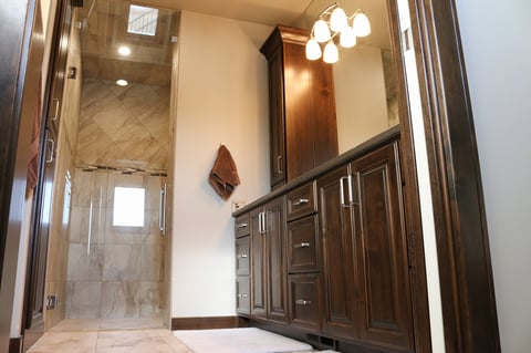 Large master bathroom with double vanity custom cabinets and walk-in shower