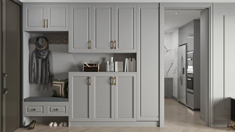 Modern gray entryway with built-in storage and cabinets above and below bench seating
