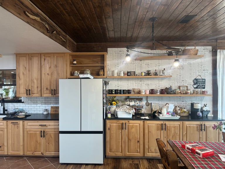 Modern kitchen with white French-door refrigerator, wooden cabinets, open shelving, subway tile backsplash, and dark wood ceiling